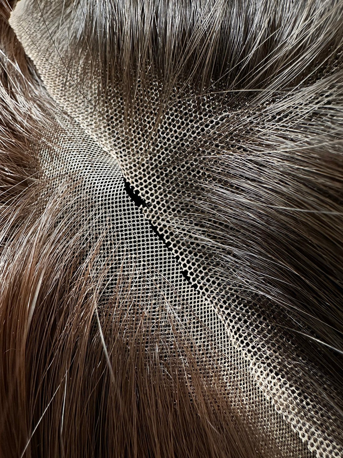 closeup of snowflake lace vs standard lace shown with brunette synthetic fibres