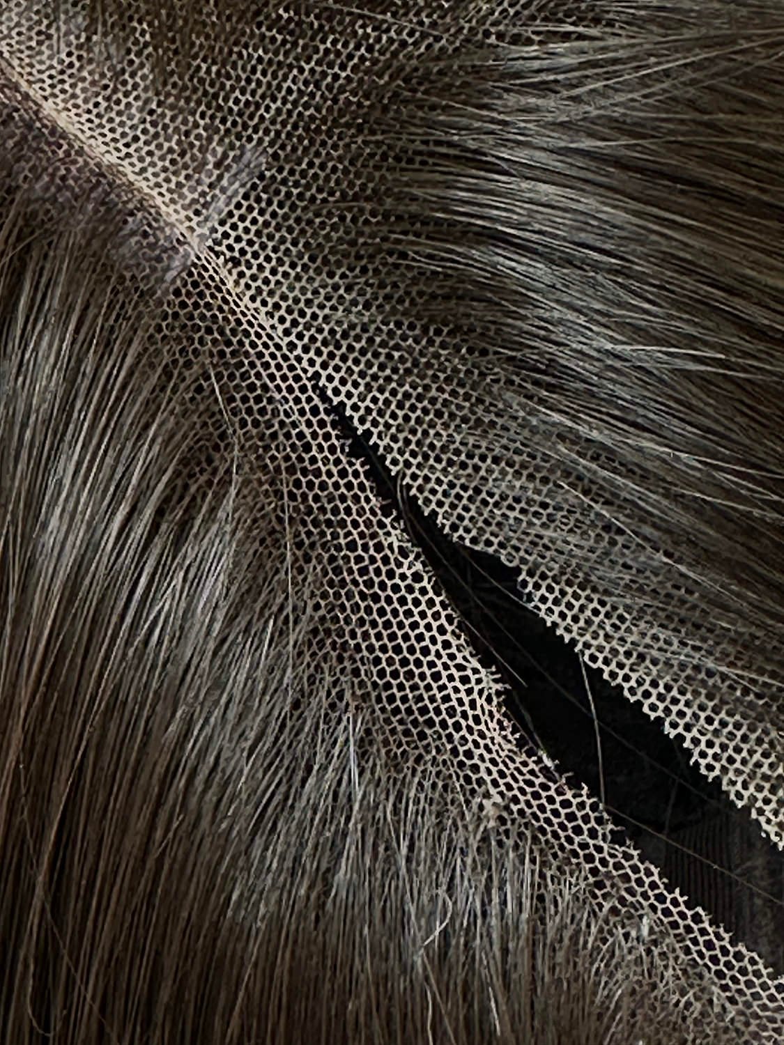 closeup of swiss lace compared with standard lace, shown with synthetic brunette fibres